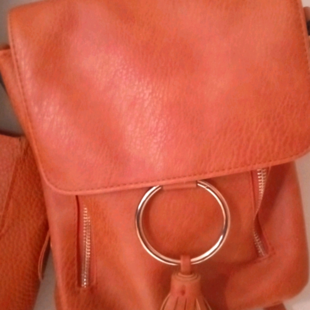 Tan mini backpack with silver zipper